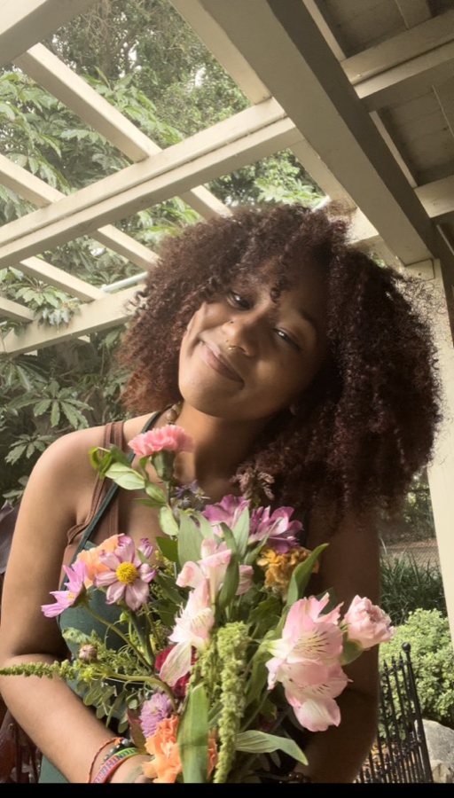 Kymari Bratton smiling while holding a bouquet of flowers