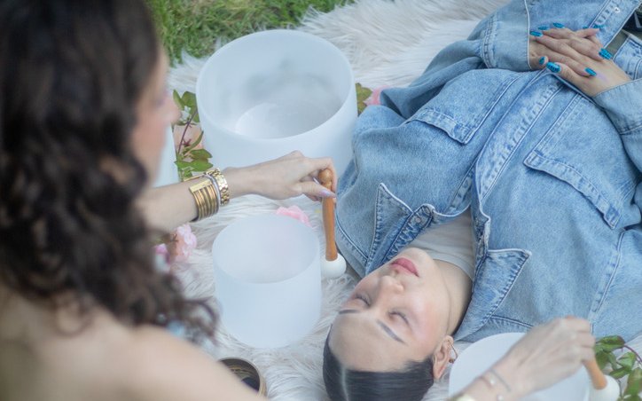 Desiree performing a nervous-system regulation ritual with a client outdoors, part of The Regulated Woman program