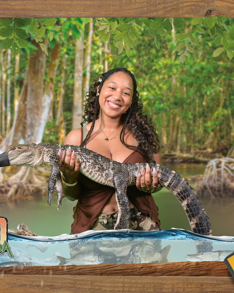 Kymari holding a young alligator at a Florida wildlife park